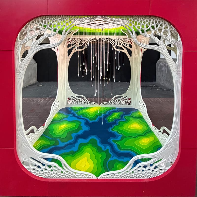 Water Torus by CreatingAs1, seen through the red cube's rounded opening: white carved trees under a green canopy, strands of hanging crystals and a swirling blue and green river floor.