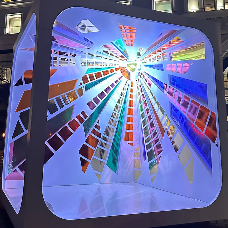 Ray of Light at night: the glass rays lit blue, violet and amber from within.
